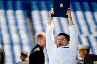 A Naval Academy graduate celebrates after receiving their diploma during the Academy's graduation and commissioning ceremony, Friday, May 24, 2019, in Annapolis, Md. (AP Photo/Will Newton)