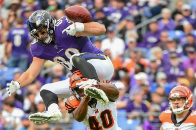BALTIMORE, MD - OCTOBER 13: Mark Andrews #89 of the Baltimore Ravens fumbles the football trying to leap over Brandon Wilson #40 of the Cincinnati Bengals during the first half at M&T Bank Stadium on October 13, 2019 in Baltimore, Maryland. (Photo by Will Newton/Getty Images)