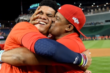 WASHINGTON, DC - OCTOBER 01: Juan Soto #22 of the Washington Nationals celebrates with his father after defeating the Milwaukee Brewers in the National League Wild Card game at Nationals Park on October 1, 2019 in Washington, DC. (Photo by Will Newton/Getty Images)
